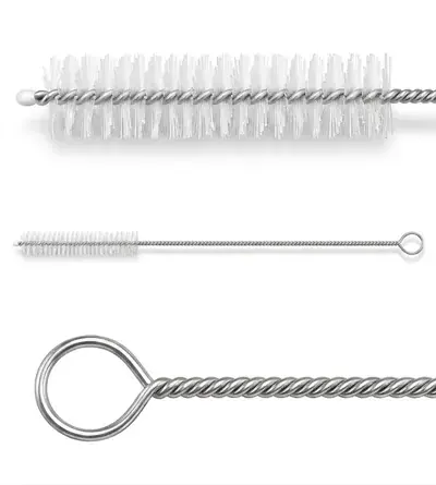 A fan of long flexible nylon tube cleaning brushes laid across a dark surface