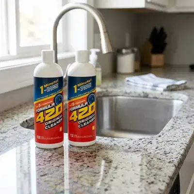 Two cleaning solution bottles beside a spotless clear glass water pipe